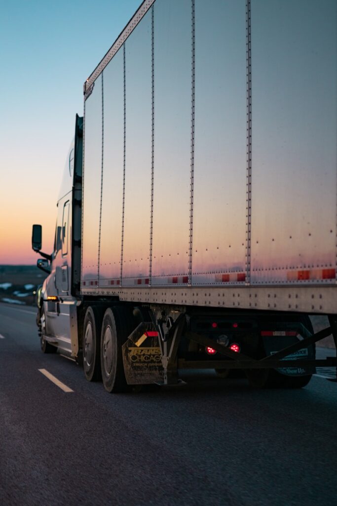 white freight truck on road during daytime